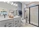 Elegant bathroom with double vanity and walk-in shower at 15100 Grove Lake Dr, Winter Garden, FL 34787