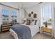 Bright bedroom with comfortable bed and large windows at 15100 Grove Lake Dr, Winter Garden, FL 34787