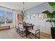 Bright dining room with large window, chandelier, and elegant table setting at 15100 Grove Lake Dr, Winter Garden, FL 34787
