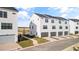 White townhouses, attached garages, paved driveways, and walkway at 15100 Grove Lake Dr, Winter Garden, FL 34787