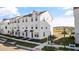 Modern townhome community with white townhouses and a lake view at 15100 Grove Lake Dr, Winter Garden, FL 34787