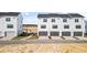 Modern townhouses with attached garages and paved driveways at 15100 Grove Lake Dr, Winter Garden, FL 34787