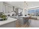 Modern kitchen with gray cabinets, quartz countertops, and island at 15100 Grove Lake Dr, Winter Garden, FL 34787