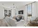 Spacious living room featuring a comfy sofa and large TV at 15100 Grove Lake Dr, Winter Garden, FL 34787