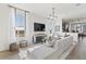 Light-filled living room with sectional sofa and open floor plan at 15100 Grove Lake Dr, Winter Garden, FL 34787