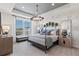 Spacious main bedroom with large window and chandelier at 15100 Grove Lake Dr, Winter Garden, FL 34787