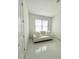 Bright bedroom with white walls, a white couch, and shiny floors at 17795 Blazing Star Cir, Clermont, FL 34714