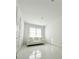 Bright bedroom with white walls, a white couch, and shiny floors at 17795 Blazing Star Cir, Clermont, FL 34714