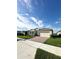 One-story house with a two-car garage and a nicely landscaped front yard at 17795 Blazing Star Cir, Clermont, FL 34714