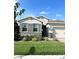 One-story house with gray shutters, stone accents, and a two-car garage at 17795 Blazing Star Cir, Clermont, FL 34714