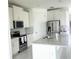Modern kitchen with white cabinets and stainless steel appliances at 17795 Blazing Star Cir, Clermont, FL 34714