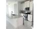 Open kitchen with white cabinets, granite counters and island at 17795 Blazing Star Cir, Clermont, FL 34714