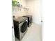 Laundry room with shelf and new Samsung washer and dryer at 17795 Blazing Star Cir, Clermont, FL 34714