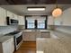 Modern kitchen with white shaker cabinets, granite countertops, and stainless steel appliances at 2101 Sanford Ave, Sanford, FL 32771