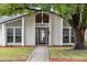 White brick home with gray accents and a landscaped walkway at 222 Flame Ave, Maitland, FL 32751