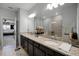 Double vanity bathroom with granite countertops and large walk-in shower at 2909 Econ Landing Blvd, Orlando, FL 32825