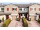 Three-unit townhome building with two-car garages and landscaped front yards at 2909 Econ Landing Blvd, Orlando, FL 32825