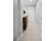 Light and airy foyer with tile flooring and a wooden storage bench at 2909 Econ Landing Blvd, Orlando, FL 32825