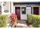 Townhome entry with red door, stone accents, and manicured landscaping at 2909 Econ Landing Blvd, Orlando, FL 32825