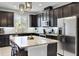 Modern kitchen with dark cabinetry, granite countertops, and stainless steel appliances at 2909 Econ Landing Blvd, Orlando, FL 32825
