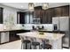 Modern kitchen with dark cabinetry, granite countertops, and stainless steel appliances at 2909 Econ Landing Blvd, Orlando, FL 32825