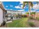 Landscaped backyard with screened pool and patio at 3683 Half Moon Dr, Orlando, FL 32812