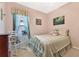 Light and airy bedroom with a comfortable bed and rocking chair at 3683 Half Moon Dr, Orlando, FL 32812