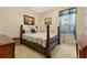 Cozy bedroom with a wooden bed frame and window at 3683 Half Moon Dr, Orlando, FL 32812