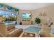 Spacious Gathering room with comfortable seating, large TV, and pool view at 3683 Half Moon Dr, Orlando, FL 32812
