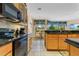 Kitchen boasts granite countertops, wood cabinets, and modern appliances at 3683 Half Moon Dr, Orlando, FL 32812