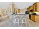Kitchen with breakfast bar, tile backsplash, and wood cabinets at 3683 Half Moon Dr, Orlando, FL 32812