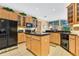 Modern kitchen with large island, granite countertops, and wood cabinets at 3683 Half Moon Dr, Orlando, FL 32812