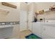 Laundry room with washer, dryer, and utility shelving at 3683 Half Moon Dr, Orlando, FL 32812