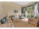 Comfortable living area featuring floral sofas and large windows at 3683 Half Moon Dr, Orlando, FL 32812