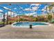 Inviting screened pool area with lush landscaping at 3683 Half Moon Dr, Orlando, FL 32812