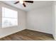 Well-lit bedroom featuring wood-look floors and a large window at 4017 Versailles Dr # 4017F, Orlando, FL 32808