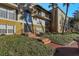 Building exterior with landscaping and palm trees at 4017 Versailles Dr # 4017F, Orlando, FL 32808