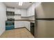 Small kitchen with white cabinets and blue oven at 4017 Versailles Dr # 4017F, Orlando, FL 32808