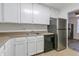 Kitchen with white cabinets and stainless steel appliances at 4017 Versailles Dr # 4017F, Orlando, FL 32808