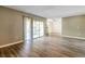 Living room with wood-look floors and sliding glass doors at 4017 Versailles Dr # 4017F, Orlando, FL 32808