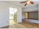 Open living room with wood-look floors and kitchen view at 4017 Versailles Dr # 4017F, Orlando, FL 32808