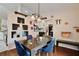 Spacious dining area with dark wood table and blue velvet chairs at 431 Pheasant Dr, Haines City, FL 33844