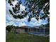 Large backyard with a screened pool and lush grass at 620 Heraldo Ct, Kissimmee, FL 34758