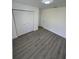 Bright bedroom with grey vinyl flooring and spacious closet at 620 Heraldo Ct, Kissimmee, FL 34758