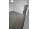 Bright bedroom with grey wood-look floors and double door closet at 620 Heraldo Ct, Kissimmee, FL 34758