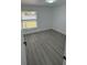 Well-lit bedroom featuring grey vinyl flooring and large window at 620 Heraldo Ct, Kissimmee, FL 34758