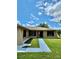 Tan house with walkway, landscaping, and a palm tree at 620 Heraldo Ct, Kissimmee, FL 34758