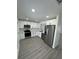 Modern kitchen with white shaker cabinets, stainless steel appliances, and grey floors at 620 Heraldo Ct, Kissimmee, FL 34758