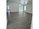 Spacious living room with grey wood-look floors and access to backyard at 620 Heraldo Ct, Kissimmee, FL 34758