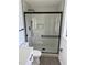 Modern shower with frameless glass door and hexagon tile floor at 620 Heraldo Ct, Kissimmee, FL 34758